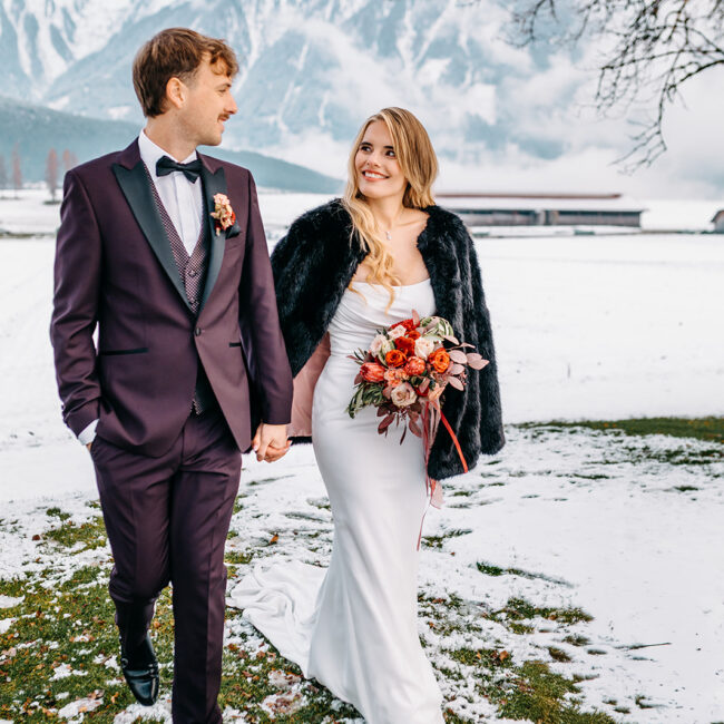 alpine wedding couple walking in snowy mountain landscape