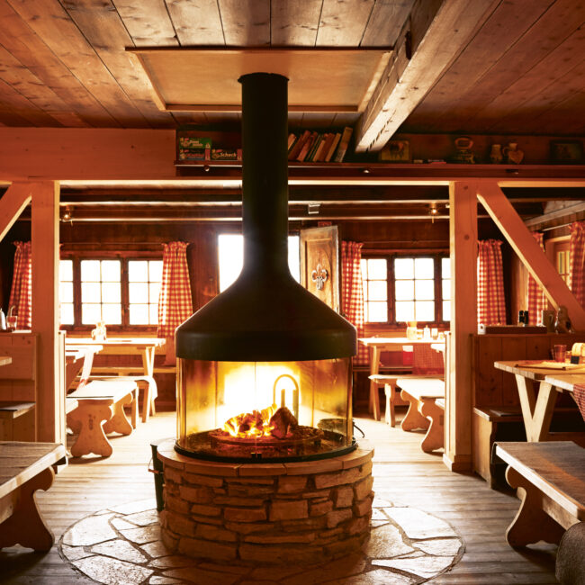 Elmauer Alm at Schloss Elmau with cozy fireplace and alpine interior atmosphere