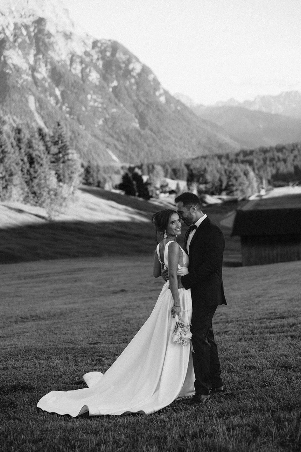 Bride and groom embracing in the Bavarian Alps during a luxury destination wedding in Germany.