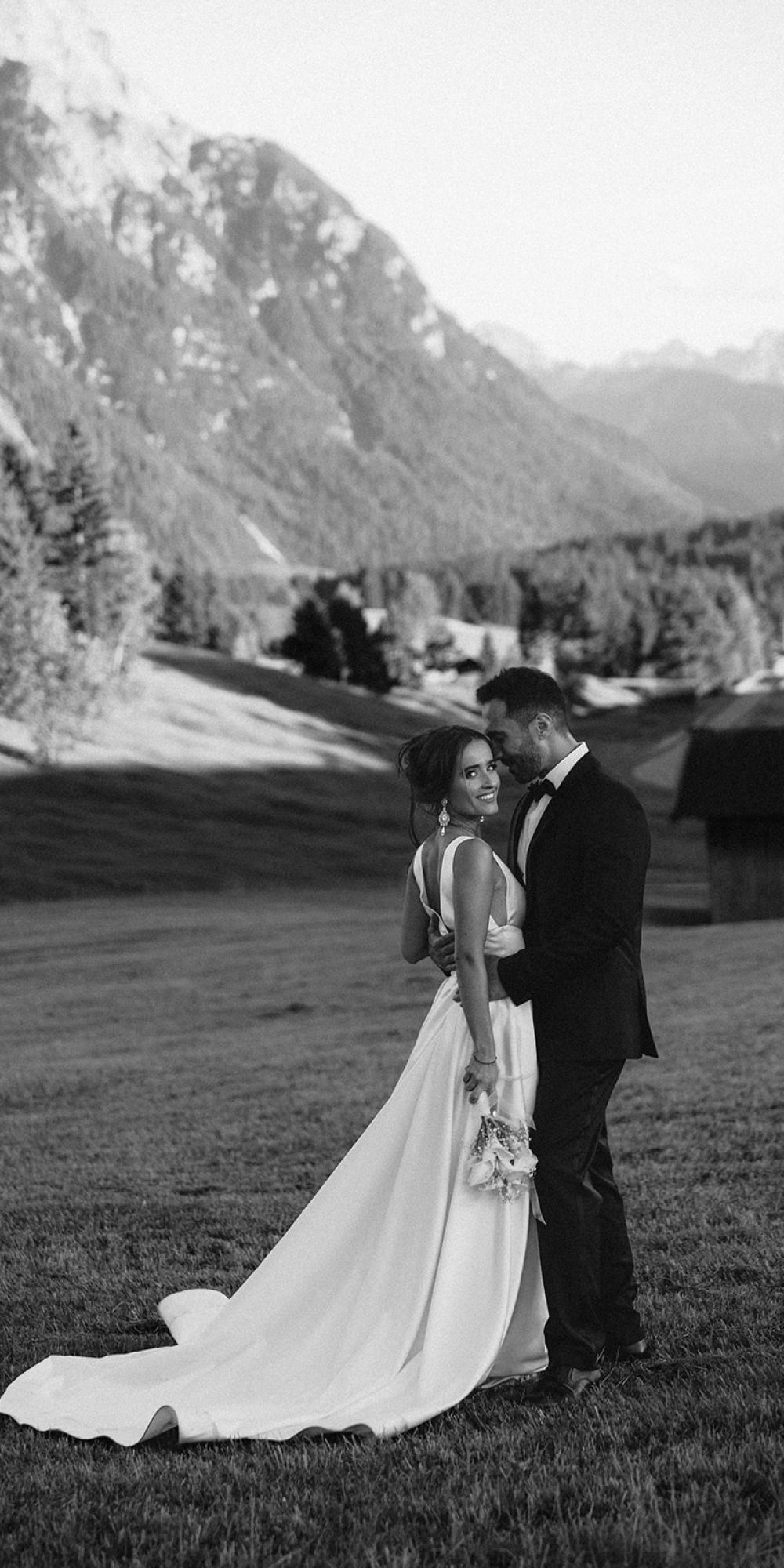Bride and groom embracing in the Bavarian Alps during a luxury destination wedding in Germany.