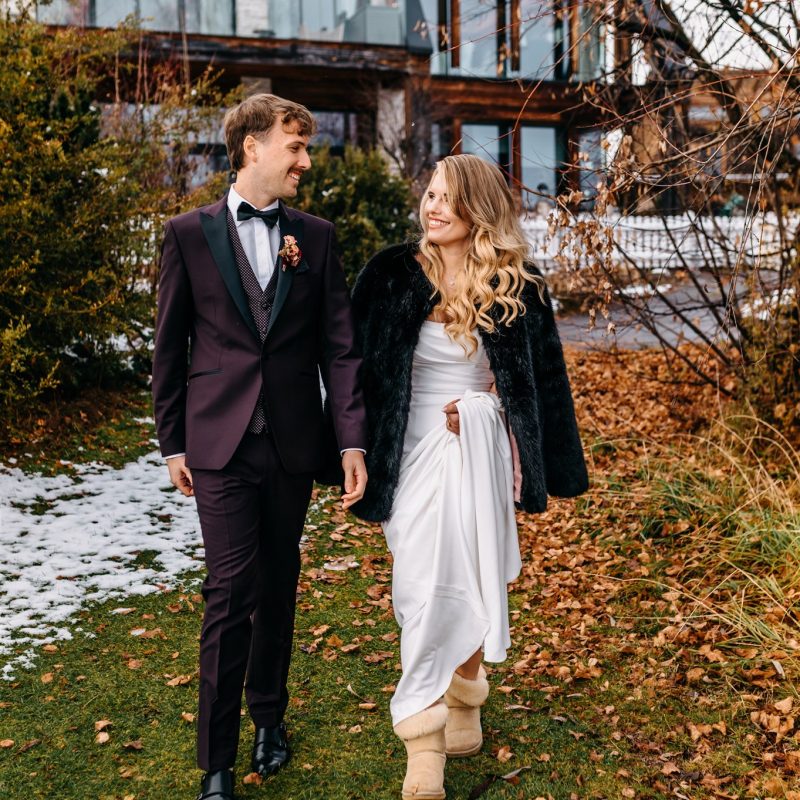 Elegant alpine winter wedding couple walking outdoors in Obermieming — planned by AWIKA WEDDINGS.